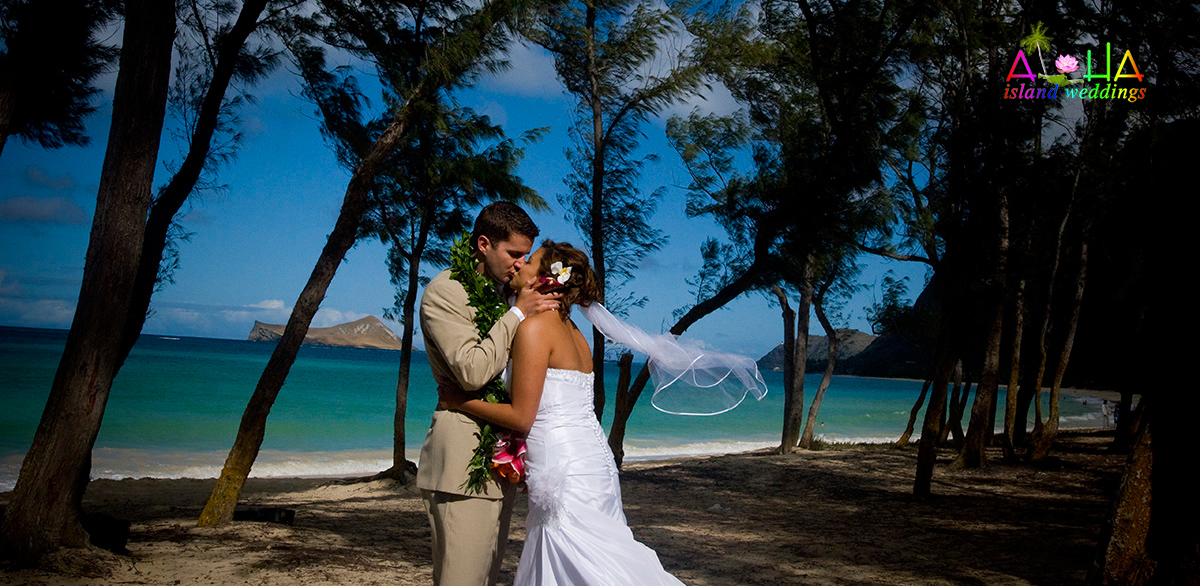 kissing in the forest by the blue water of the Pacific